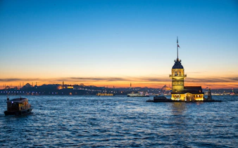 Sundown view of Istanbul skyline with Maiden's Tower and Bosphorus, Turkey.