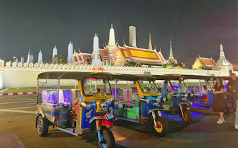 Tuk tuks parked in front of the Grand Palace at night, Bangkok.