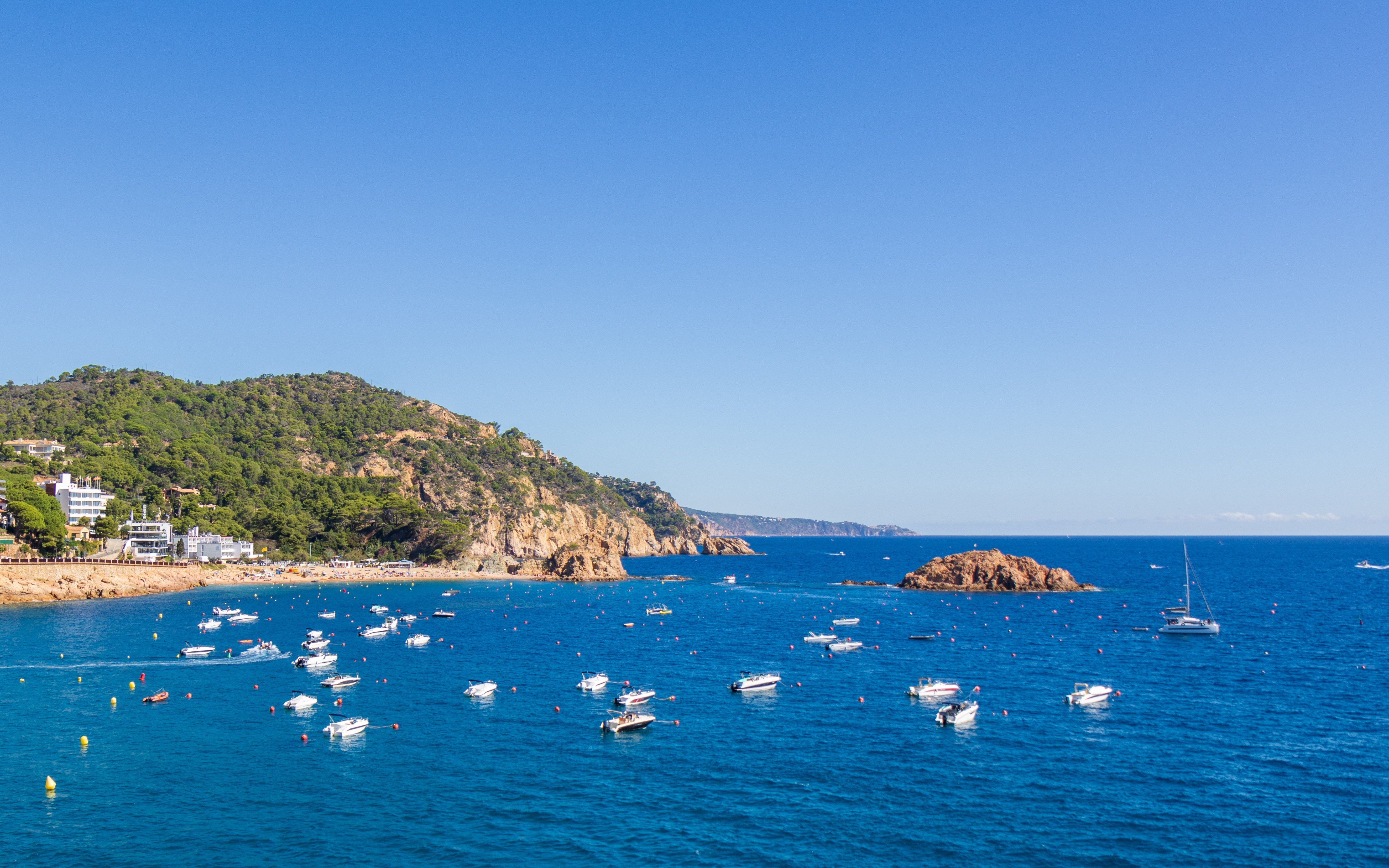 Boats on the blue waters of Costa Brava, Tossa de Mar, Catalonia, Spain.