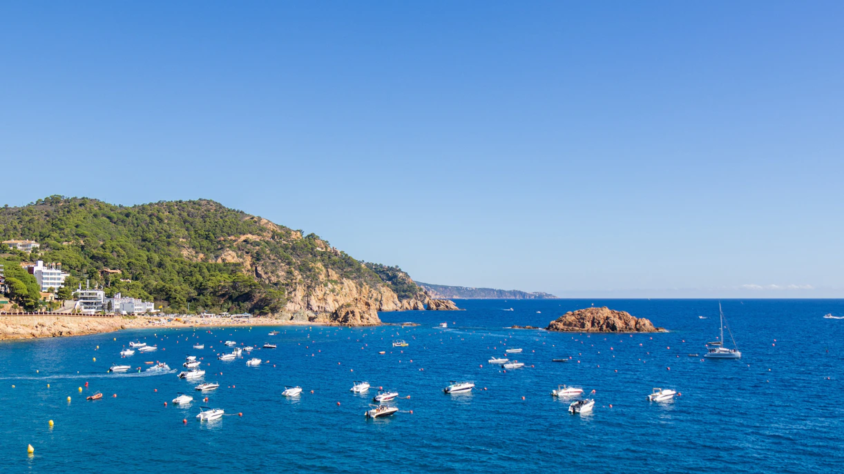 Boats on the blue waters of Costa Brava, Tossa de Mar, Catalonia, Spain.