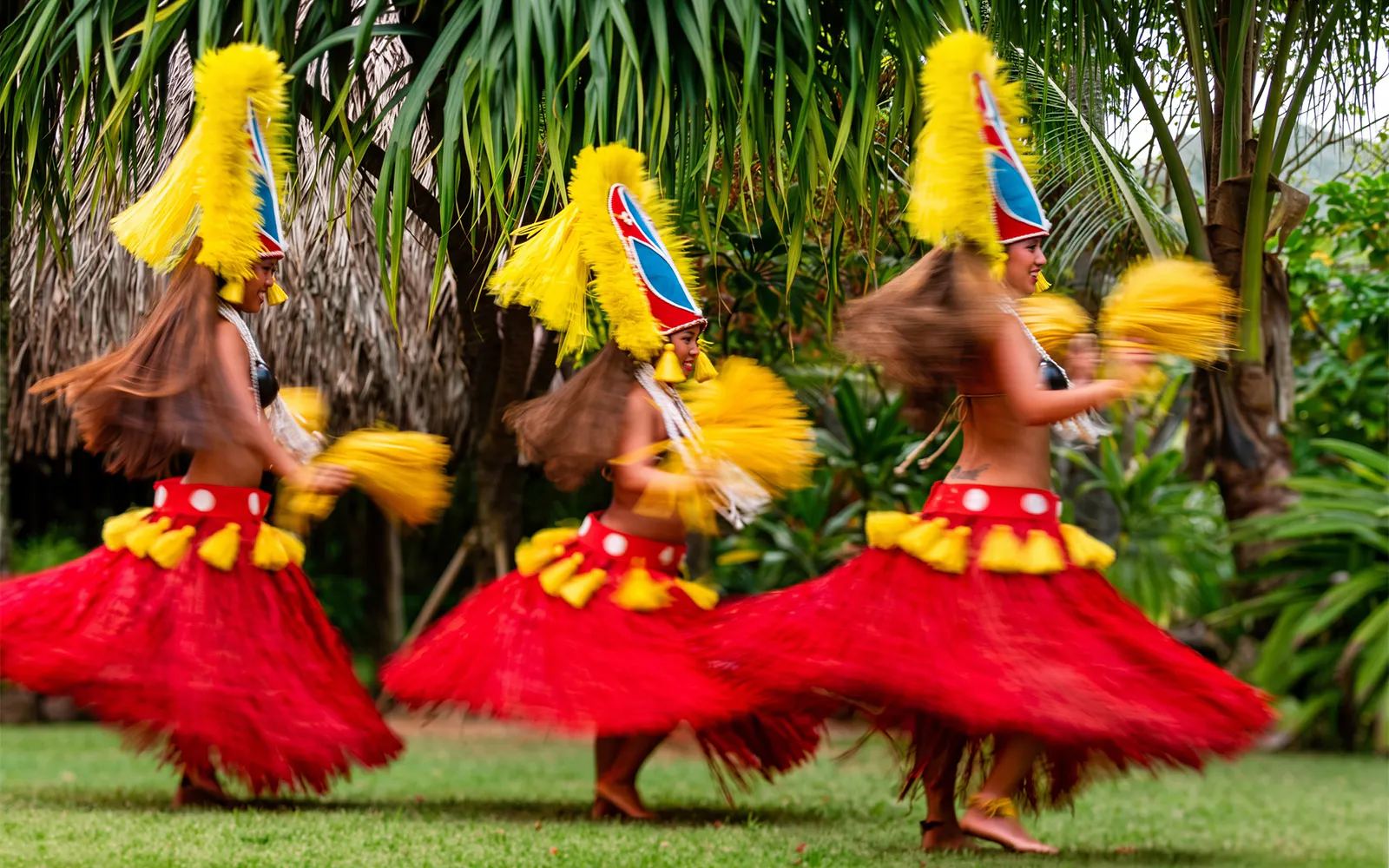 Dancers in traditional attire performing at Smiths Family Garden Luau, Hawaii.