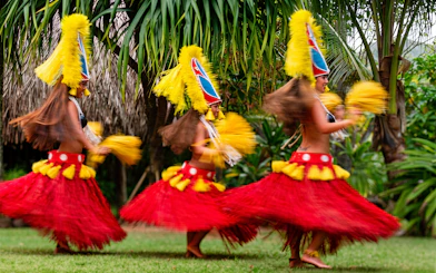 Dancers in traditional attire performing at Smiths Family Garden Luau, Hawaii.