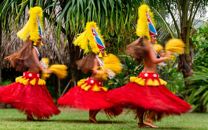 Dancers in traditional attire performing at Smiths Family Garden Luau, Hawaii.