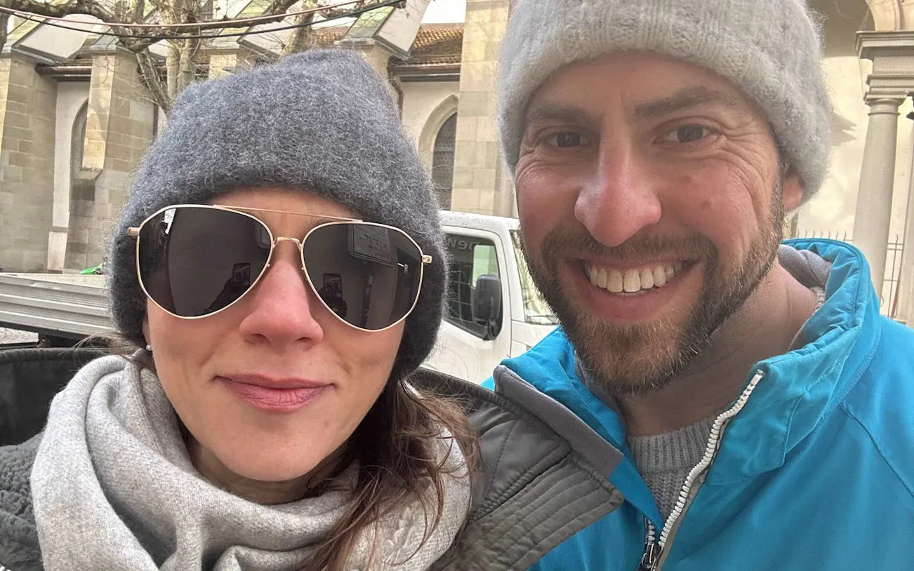 Couple enjoying Zurich self-guided city exploration game near historic architecture.