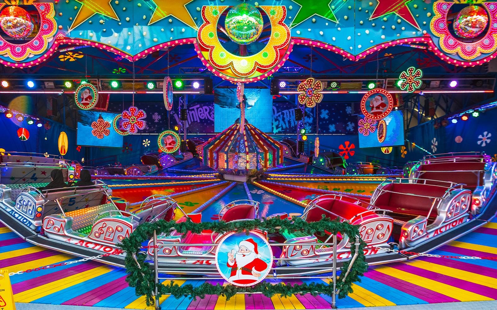 Amusement ride with colorful lights at Christmas funfair in Winter Wonderland, London.