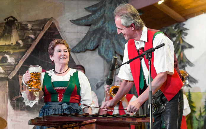 Tyrolean folk musicians performing with traditional attire and instruments.