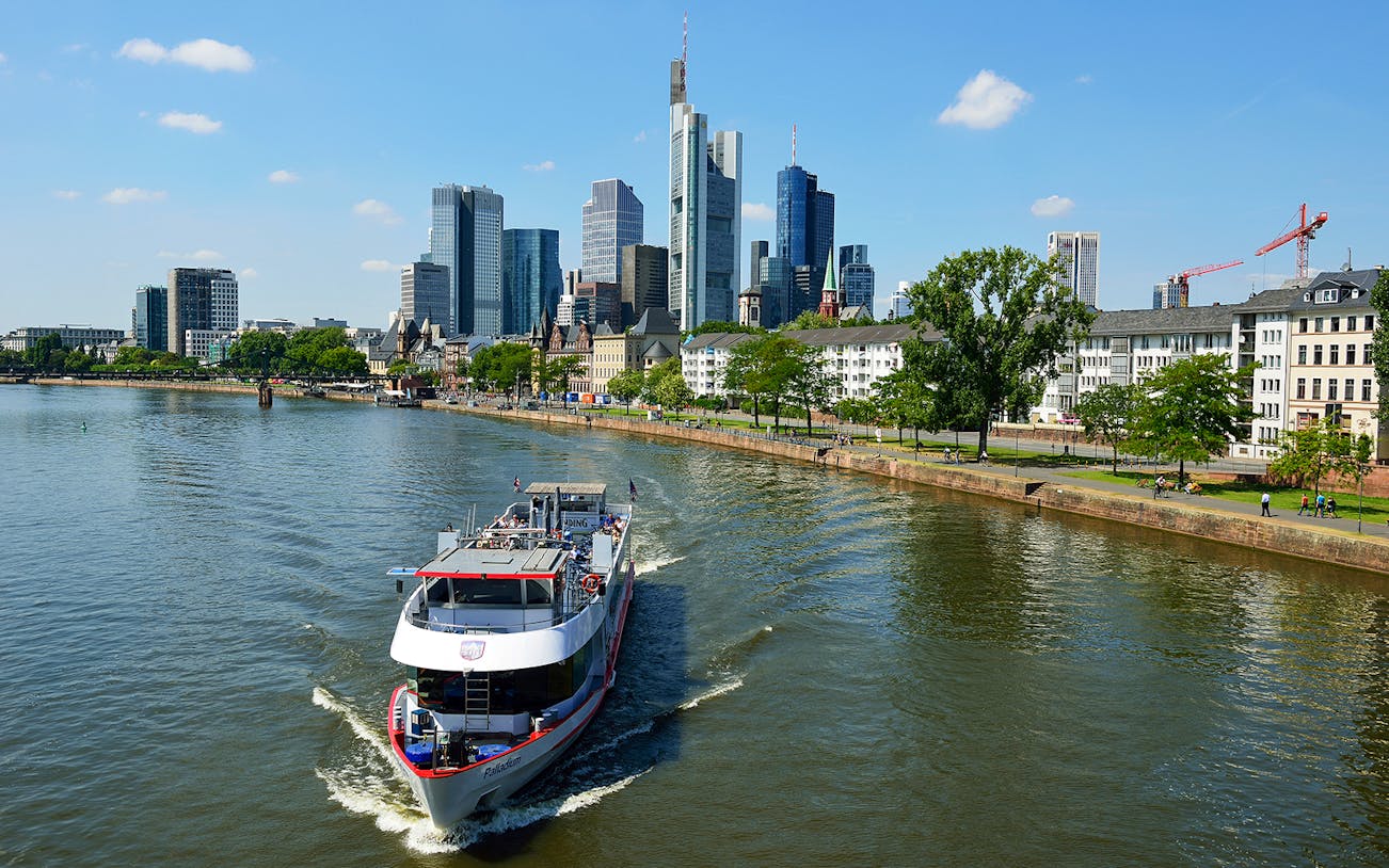 Panorama Cruise boat on the Main River with Frankfurt skyline in the background.