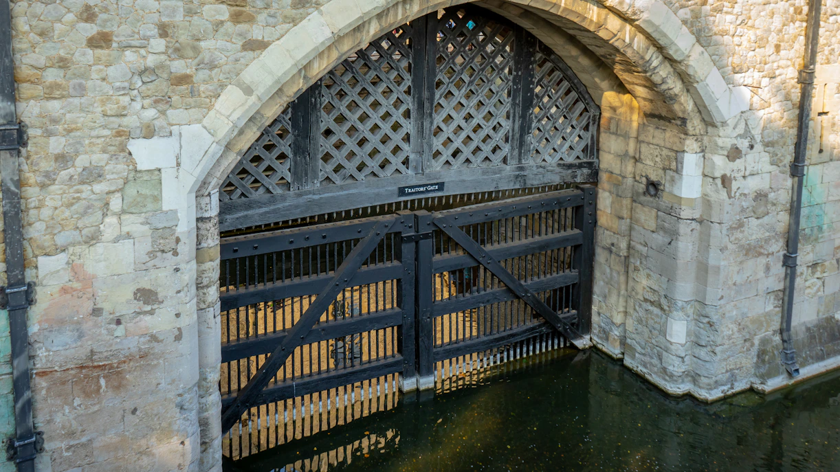 Traitors' Gate at the Tower of London, UK, with water reflecting the historic stone archway.