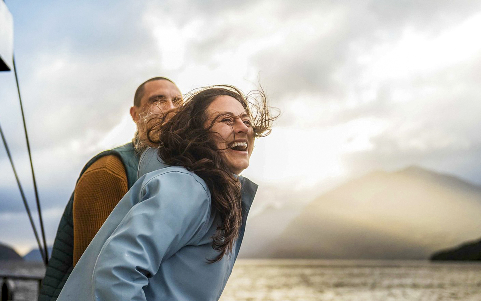 Couple enjoying the view on Doubtful Sound overnight cruise from Manapouri.
