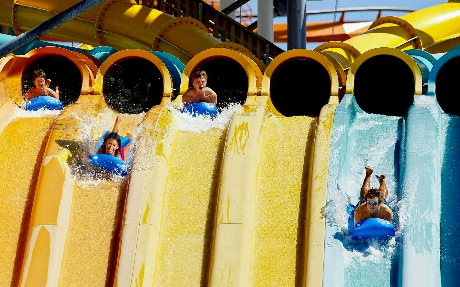 Visitors enjoying water slides at Hurricane Harbor Chicago.