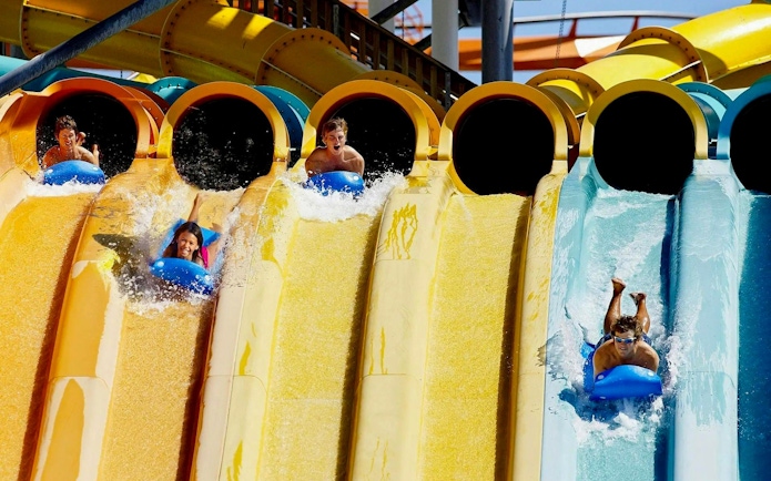 Visitors enjoying water slides at Hurricane Harbor Chicago.
