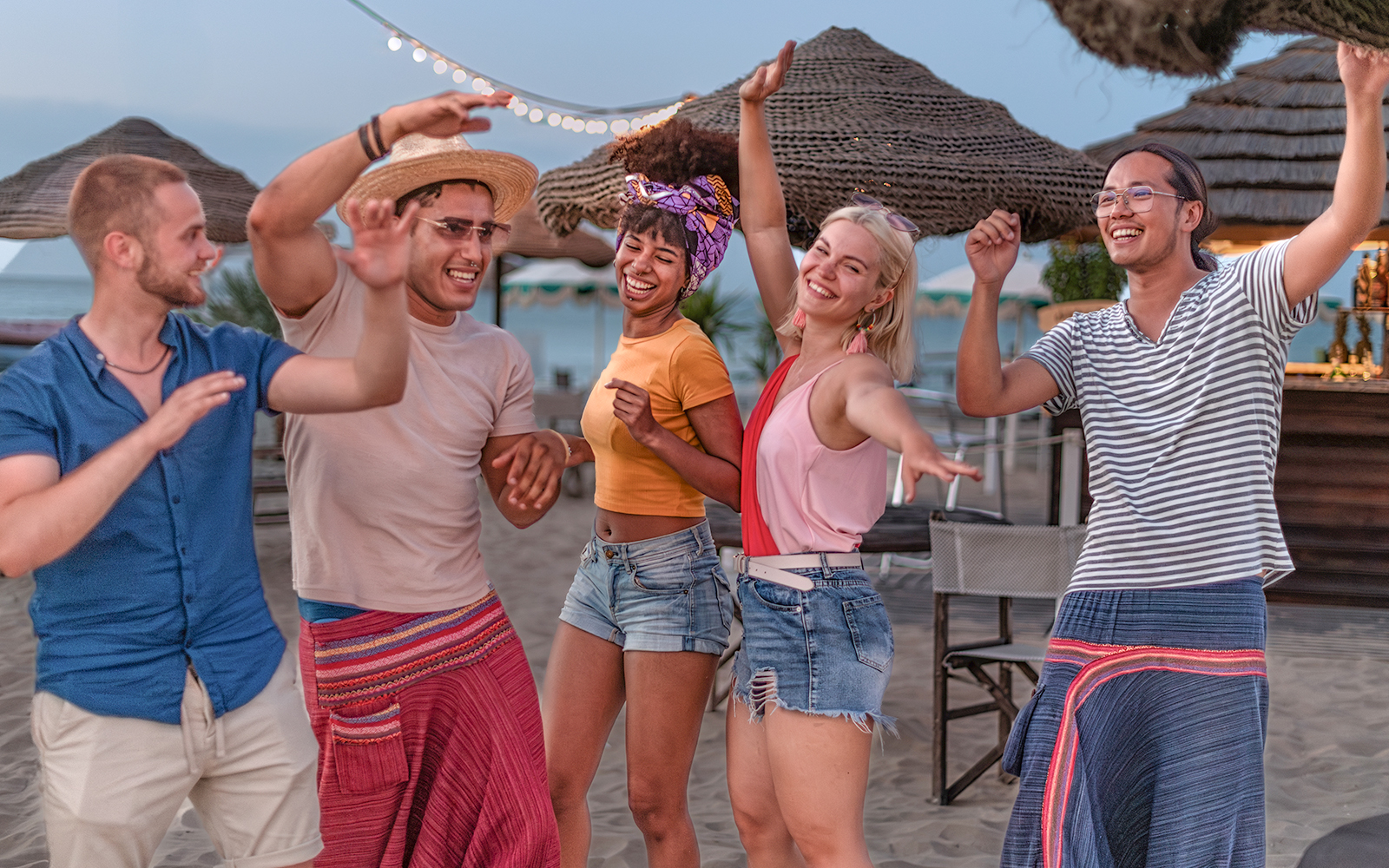 Group of people dancing on an island at a club in open air