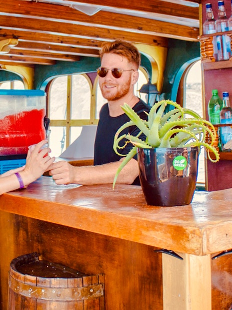 Bar on a day cruise from Rhodes with people enjoying drinks.