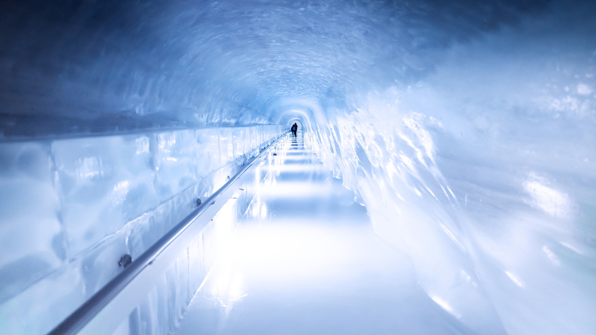 Person walking through an ice tunnel at Matterhorn Glacier Paradise.