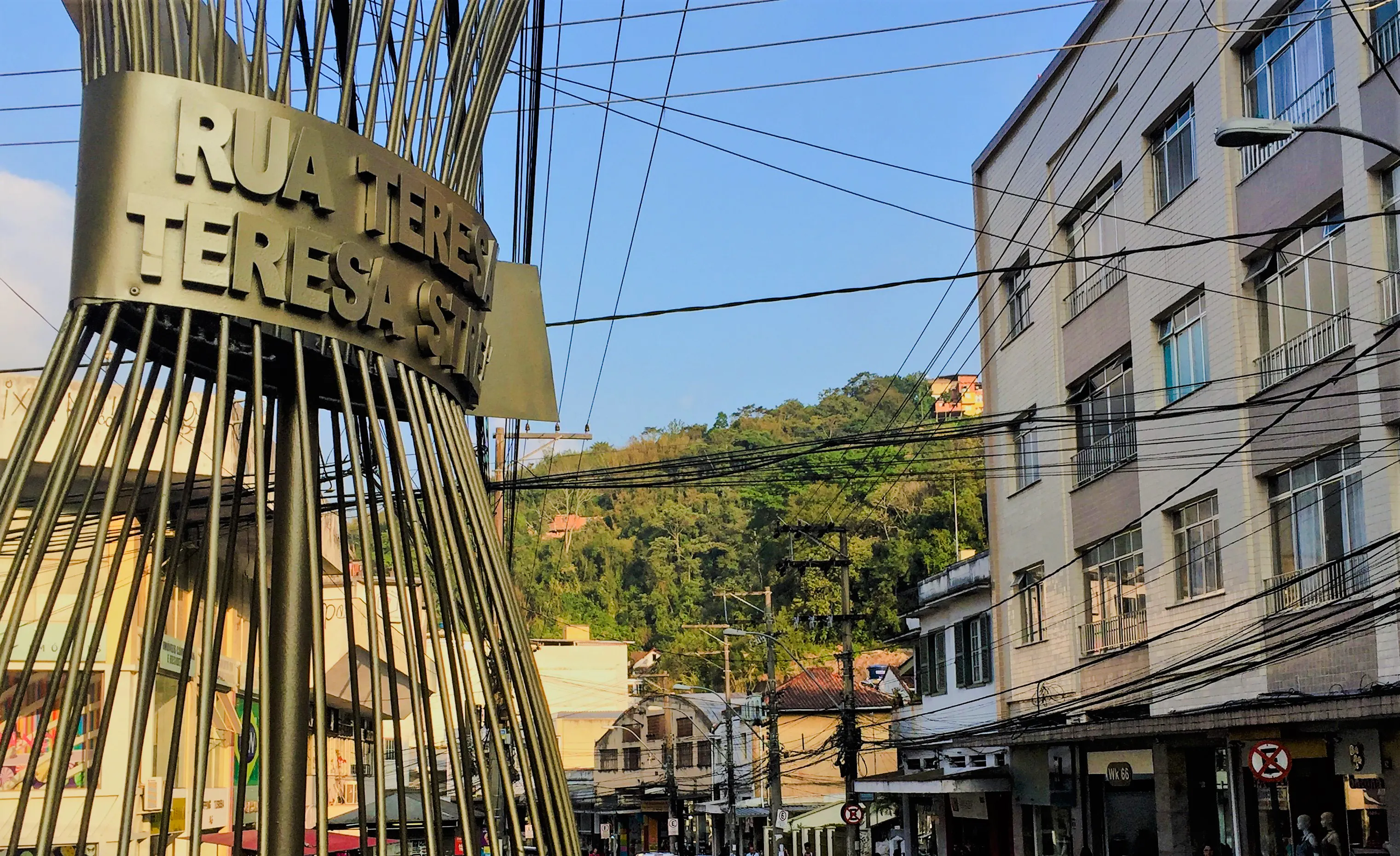 Rua Teresa street sign with buildings and hills in Petrópolis, Rio de Janeiro.