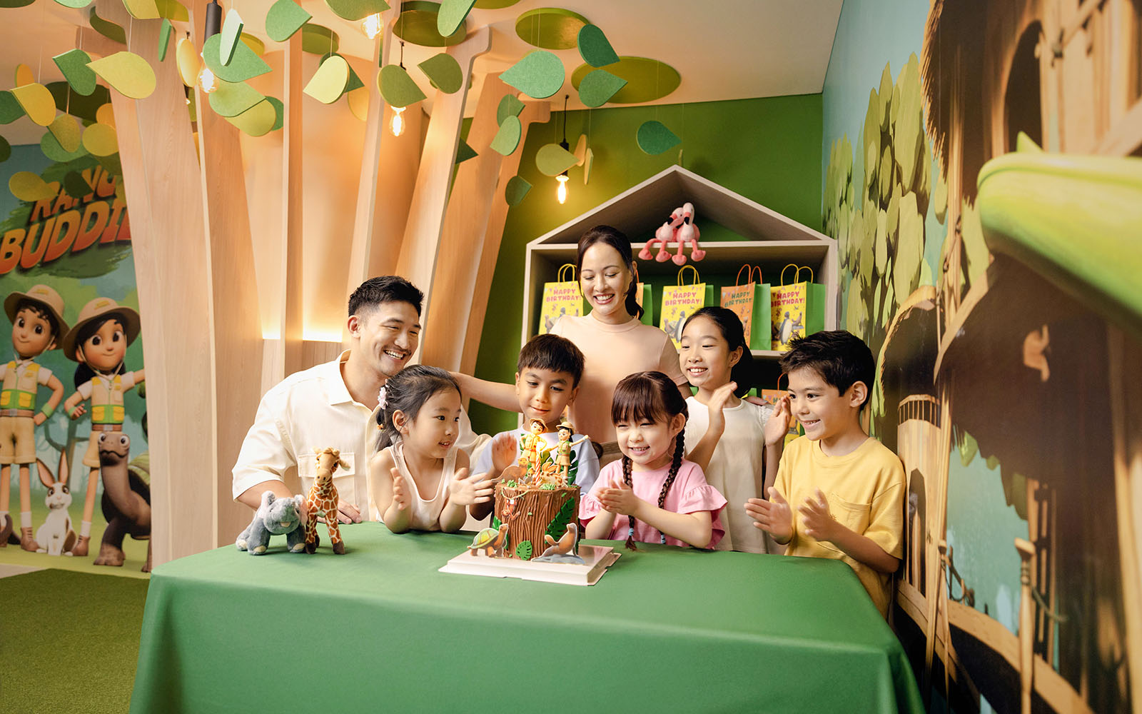 Children celebrating a birthday at Curiosity Cove with a themed cake and decorations.