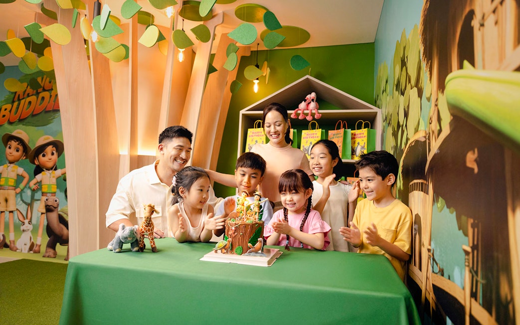 Children celebrating a birthday at Curiosity Cove with a themed cake and decorations.