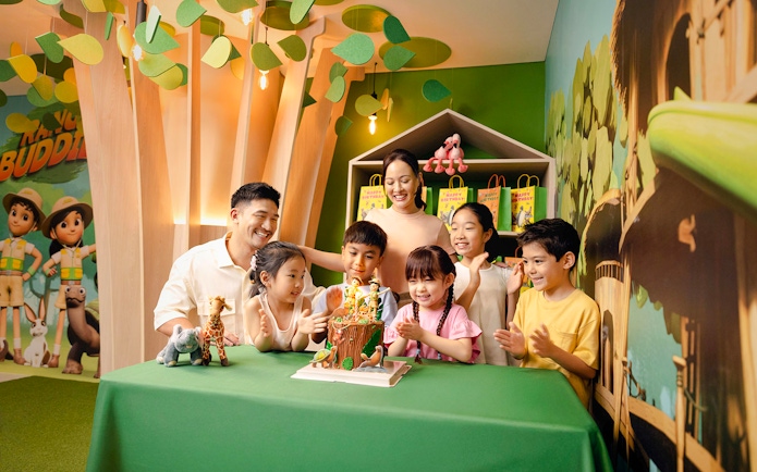 Children celebrating a birthday at Curiosity Cove with a themed cake and decorations.