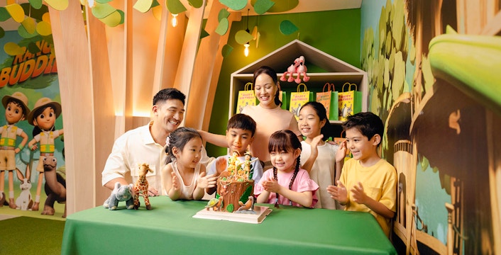 Children celebrating a birthday at Curiosity Cove with a themed cake and decorations.