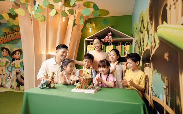 Children celebrating a birthday at Curiosity Cove with a themed cake and decorations.