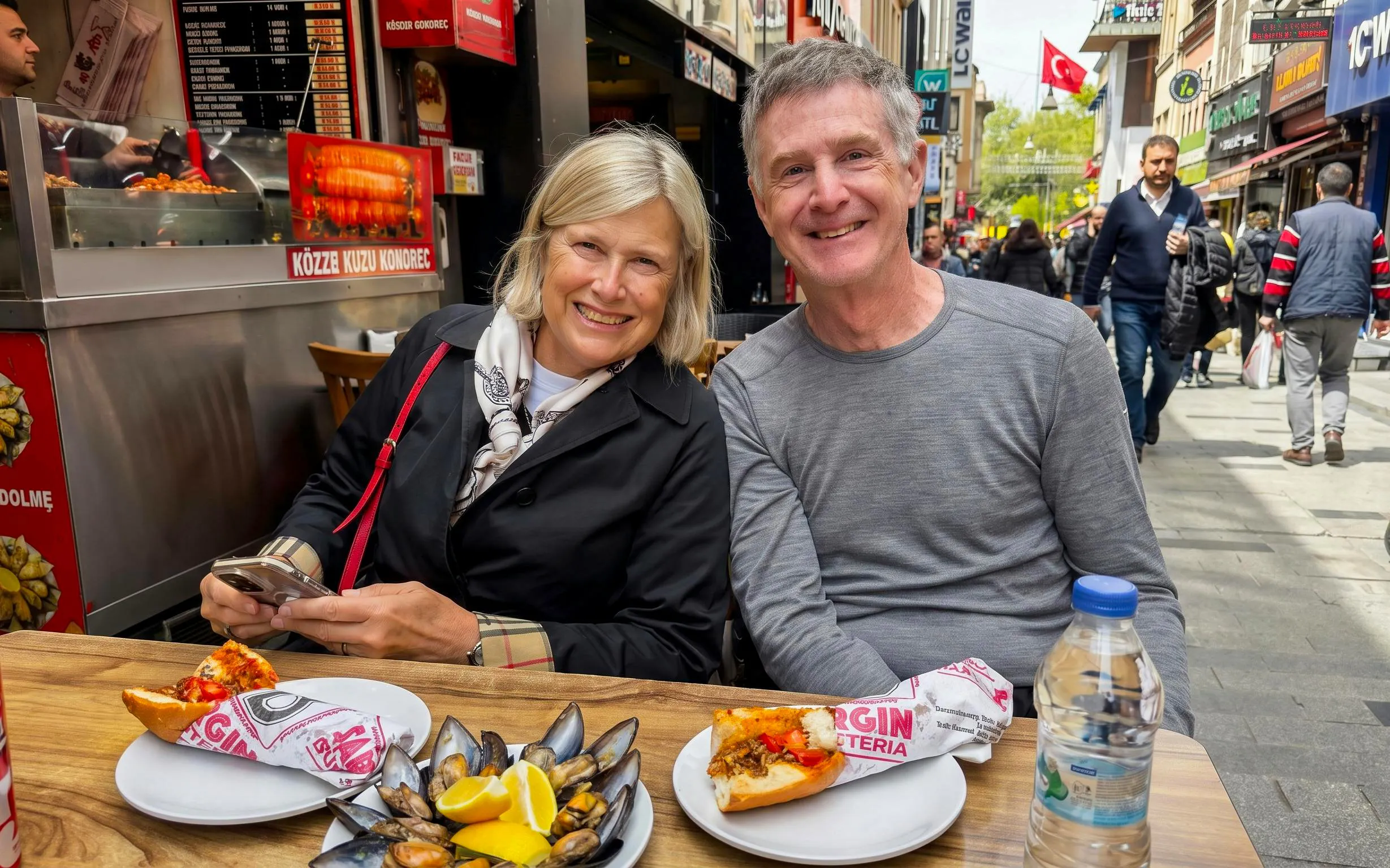 Couple enjoying street food at an outdoor cafe during an Istanbul food tour.