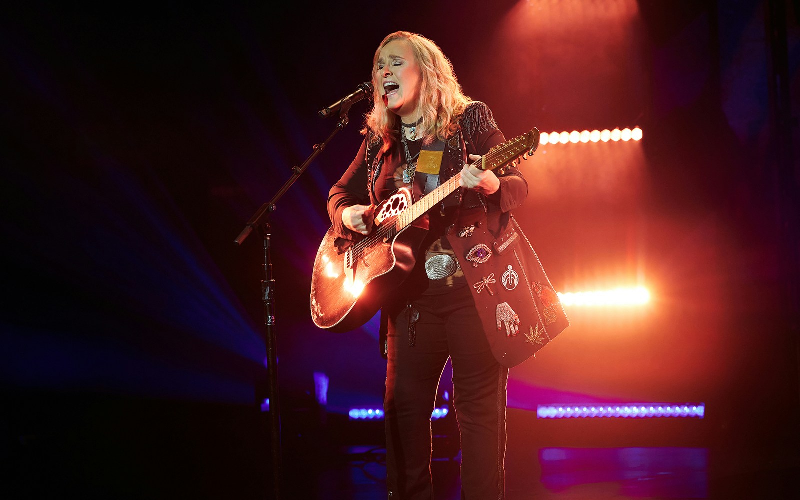 Singer performing on stage with a guitar during "Melissa Etheridge: My Window" show.