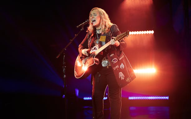 Singer performing on stage with a guitar during "Melissa Etheridge: My Window" show.