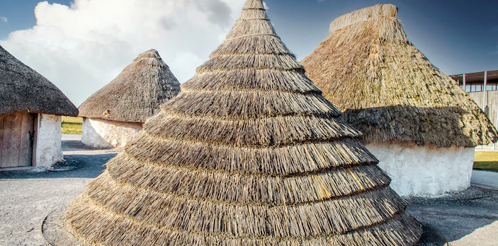 Neolithic straw cone-shaped houses near Stonehenge, England.