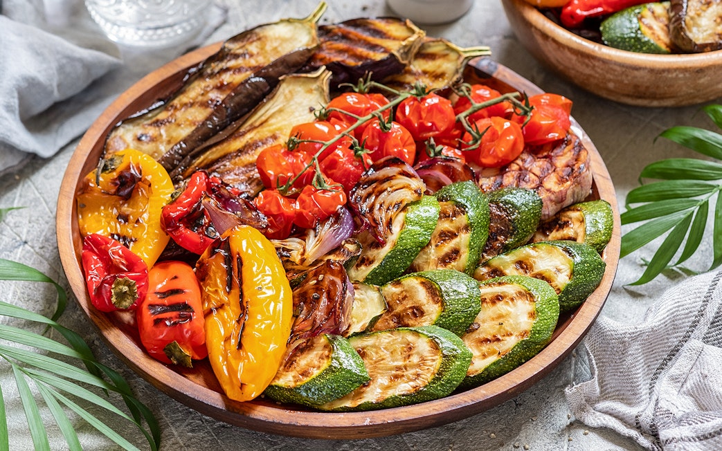 Grilled vegetables platter at the Medieval Dinner Show featuring peppers, zucchini, and eggplant.