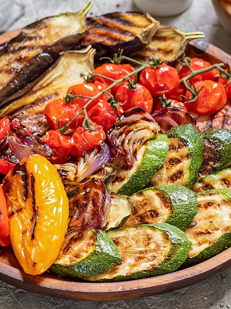 Grilled vegetables platter at the Medieval Dinner Show featuring peppers, zucchini, and eggplant.
