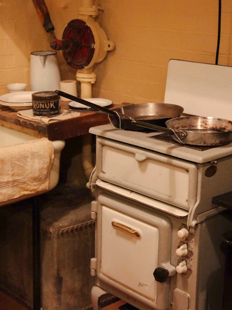 Kitchen area in Churchill War Rooms with vintage stove and sink.