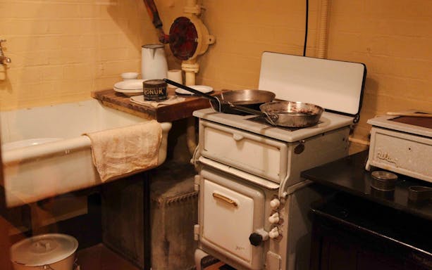Kitchen area in Churchill War Rooms with vintage stove and sink.