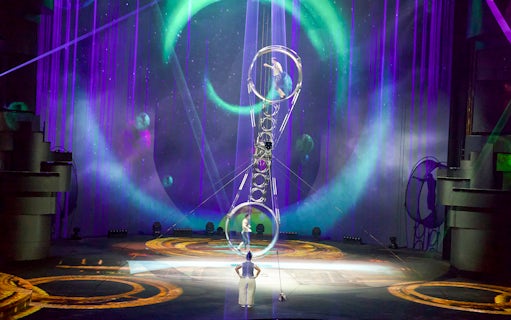 Acrobats performing at La Perle by Dragone in Dubai with vibrant stage lighting.
