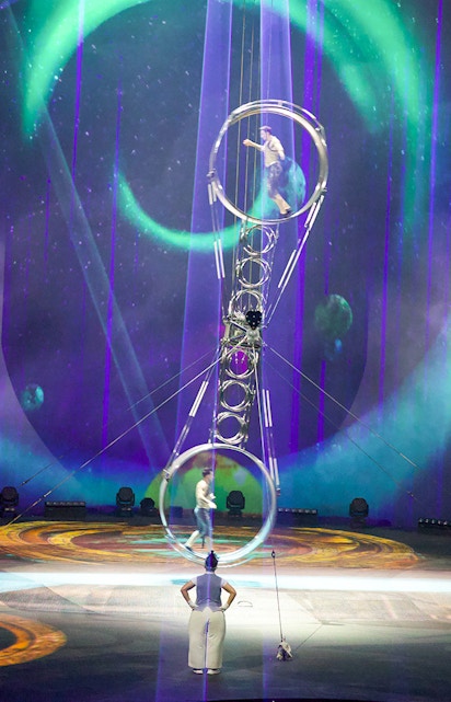 Acrobats performing at La Perle by Dragone in Dubai with vibrant stage lighting.