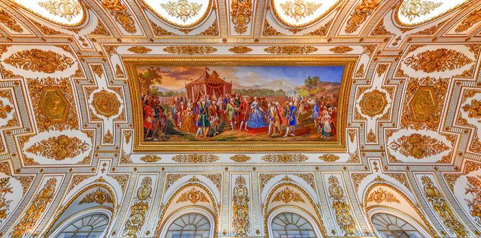 Ceiling fresco and ornate decorations at the Royal Palace of Caserta, Italy.
