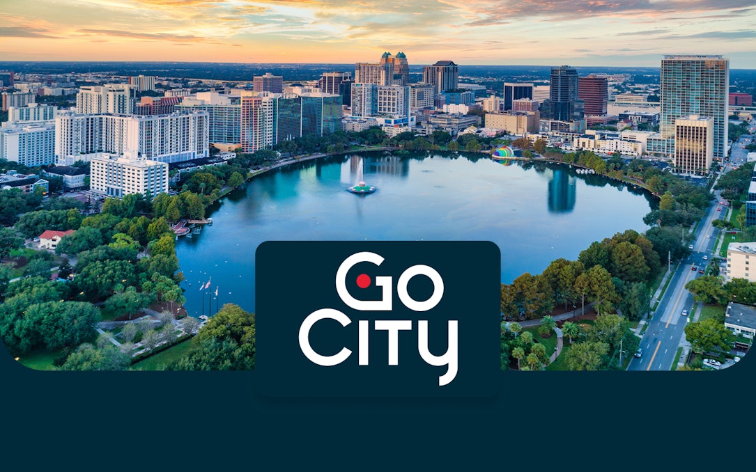 Aerial view of downtown Orlando skyline and Lake Eola at sunset.