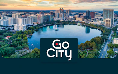 Aerial view of downtown Orlando skyline and Lake Eola at sunset.