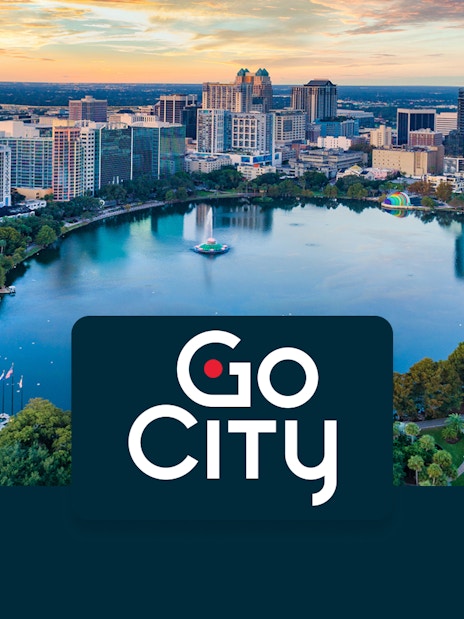 Aerial view of downtown Orlando skyline and Lake Eola at sunset.