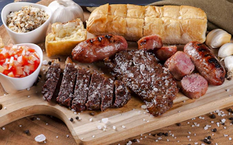 Assorted grilled meats and sides at a Brazilian steakhouse in Rio de Janeiro.