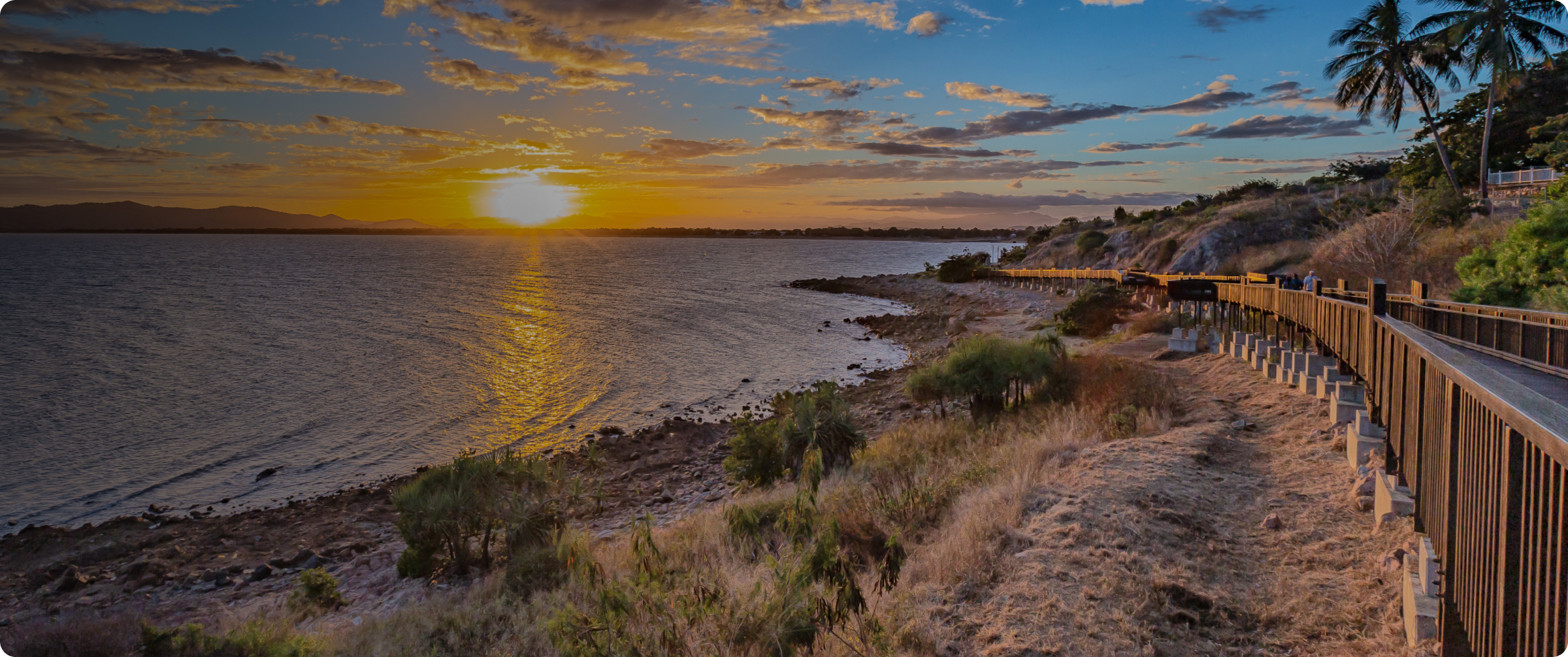 Sunset view over the ocean from a coastal walkway in Townsville.