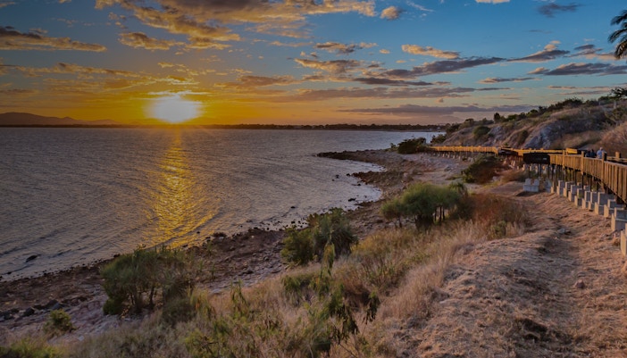 Sunset view over the ocean from a coastal walkway in Townsville.