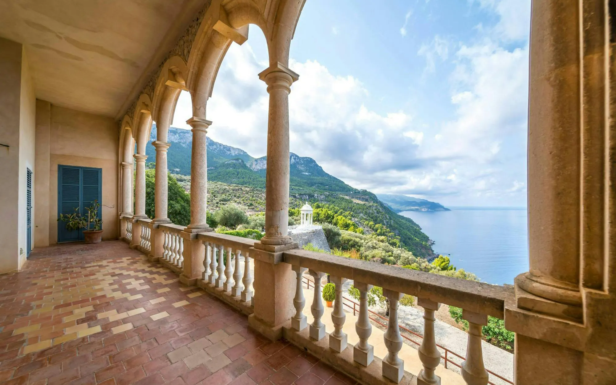 Balcony view from Valldemossa Charterhouse overlooking mountains and sea in Mallorca, Spain.