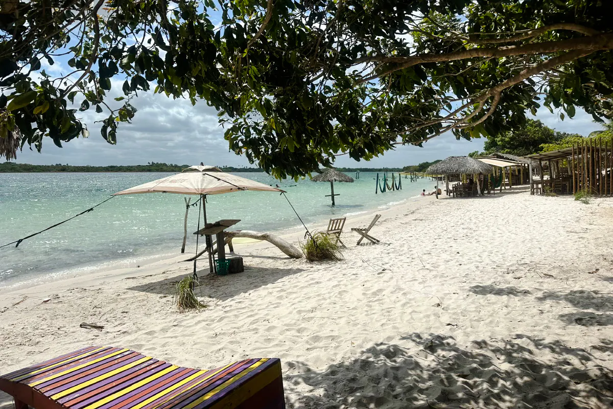 Beach with water hammocks and chairs in Jericoacoara, Brazil.