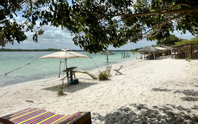 Beach with water hammocks and chairs in Jericoacoara, Brazil.