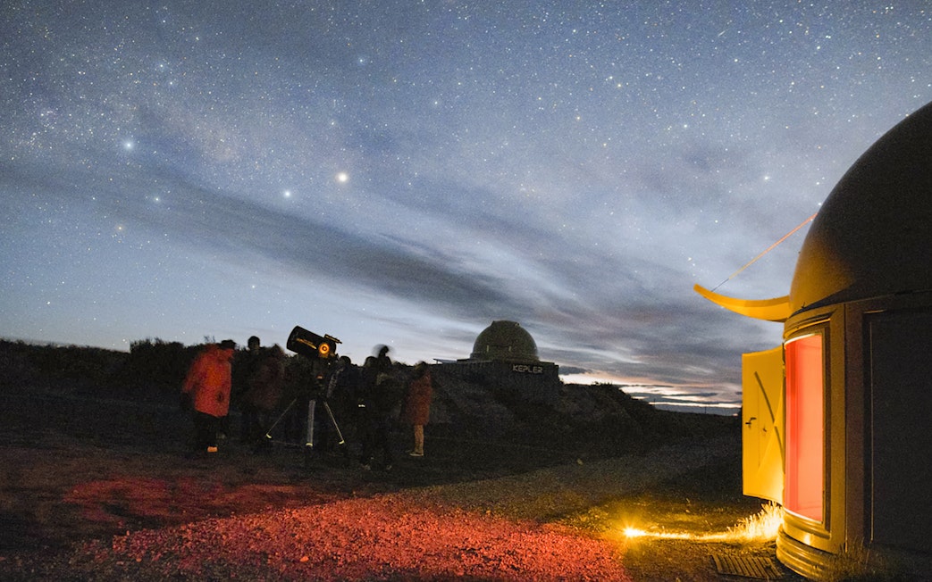 Nighttime stargazing at The Crater Observatory with telescopes and a starry sky.
