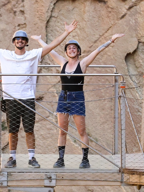 Tourists on a platform at Caminito del Rey with mountain backdrop, Malaga.