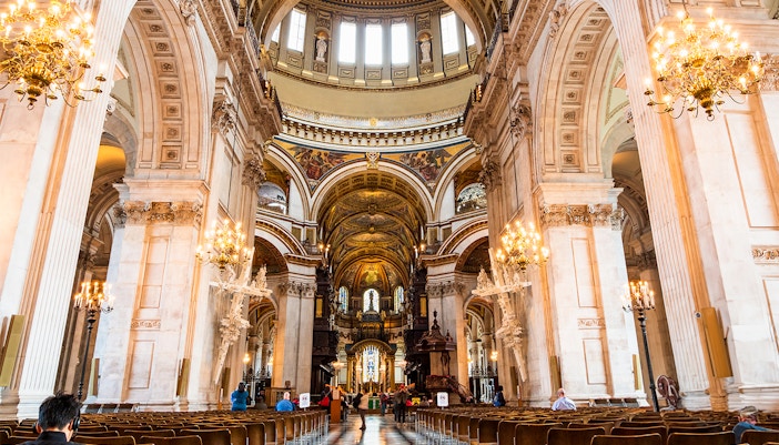 St Paul's Cathedral London interior view towards the High Altar with ornate arches and chandeliers.