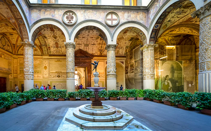 Palazzo Vecchio Museum courtyard with ornate columns and fountain, Florence.