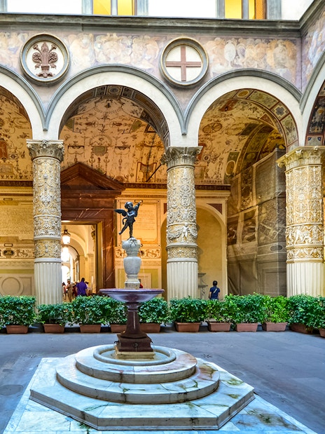 Palazzo Vecchio Museum courtyard with ornate columns and fountain, Florence.