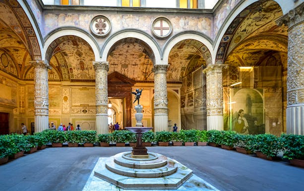 Palazzo Vecchio Museum courtyard with ornate columns and fountain, Florence.
